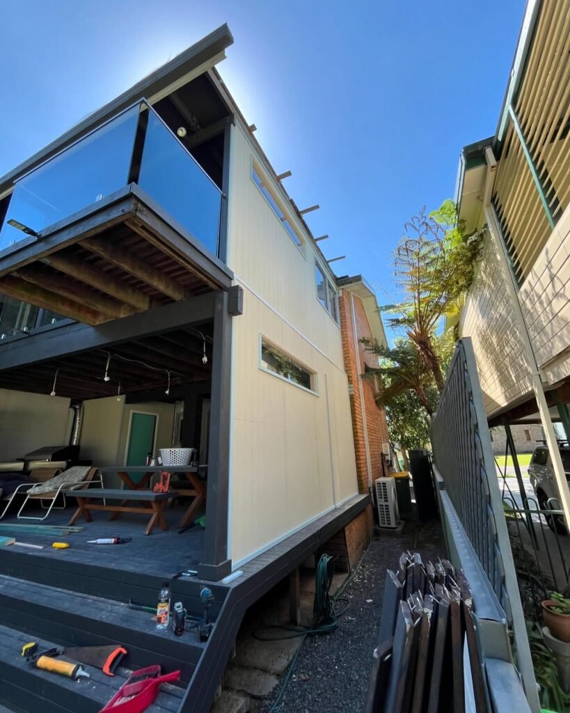Deck enclosure with new cladding and high windows