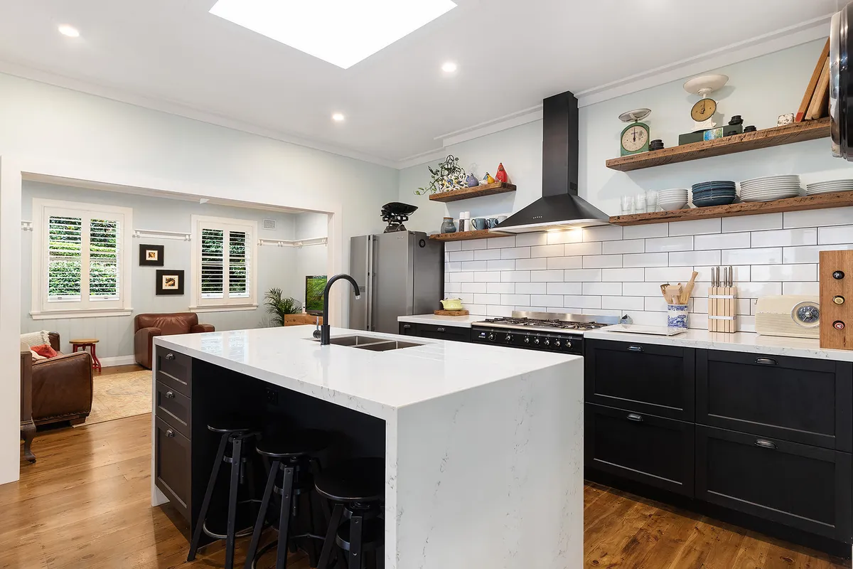 Renovated kitchen with island bench and open shelving